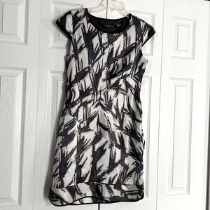 Asymmetrical design with gathering at the sides of dress makes it a show stopper